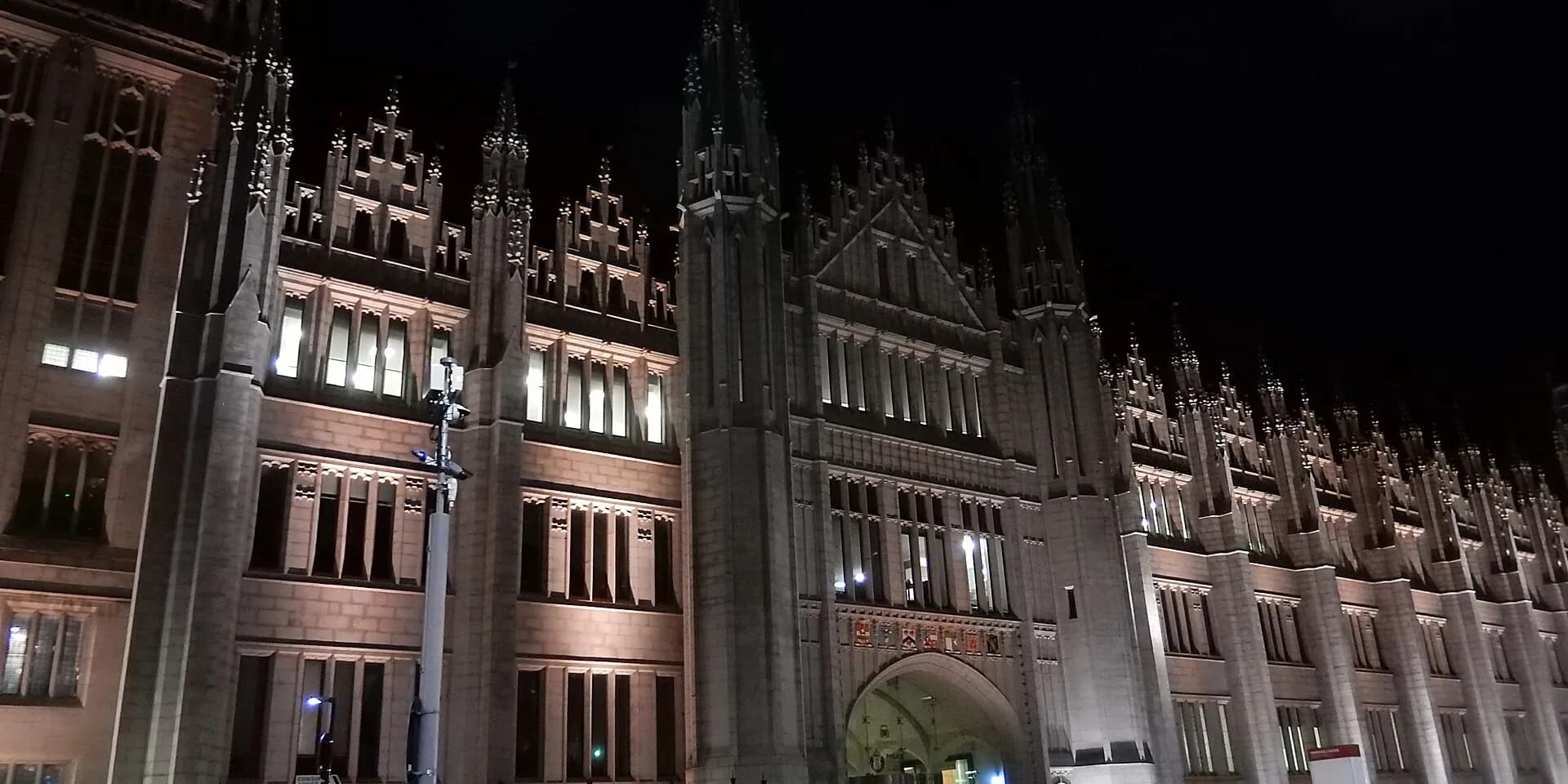 The tall granite spires of Marischal College in Aberdeen, floodlit at night