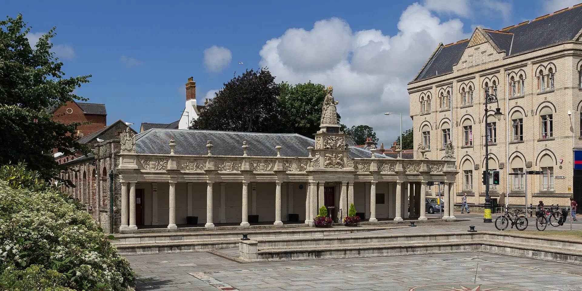 Queen Anne's Walk, a colonnade with a statue on top, beside the old buildings of Barnstaple's quay