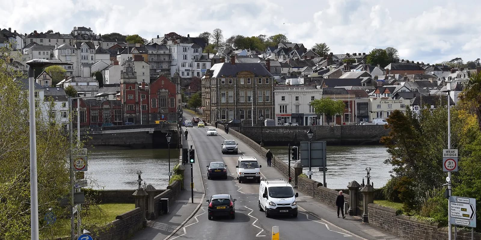 Bideford's old stone bridge over the River Torridge, with the town's houses rising up the hill beyond