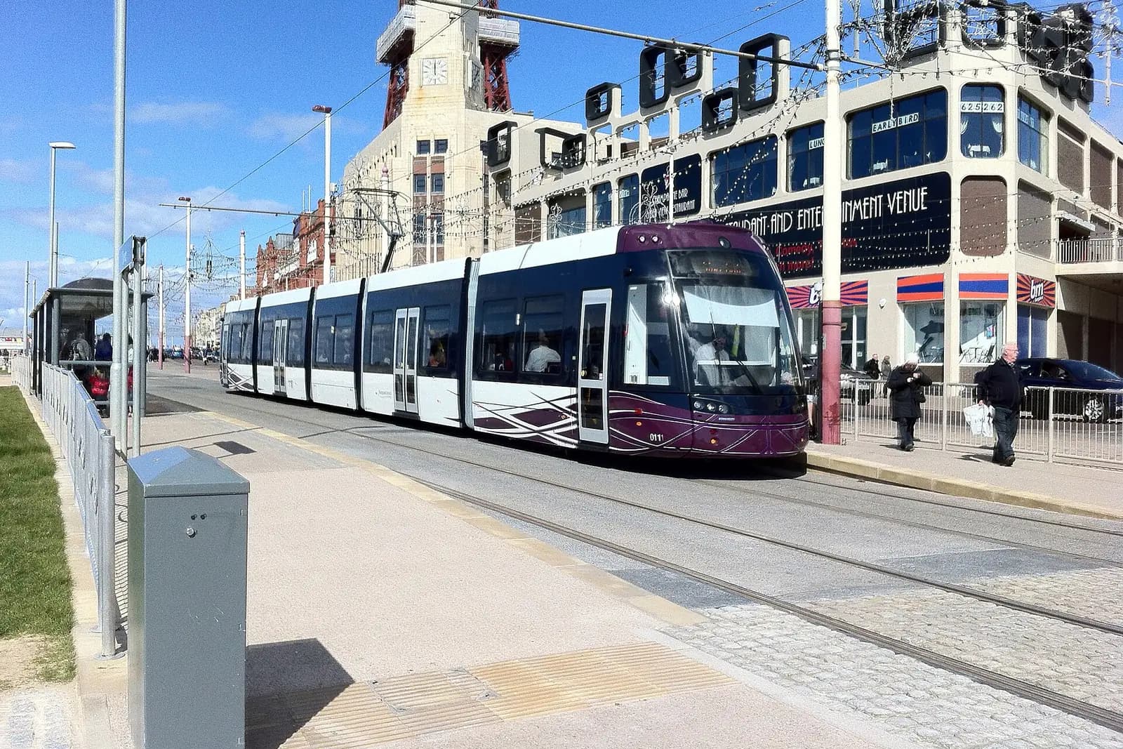 A purple and white tram at the Tower stop on the promenade