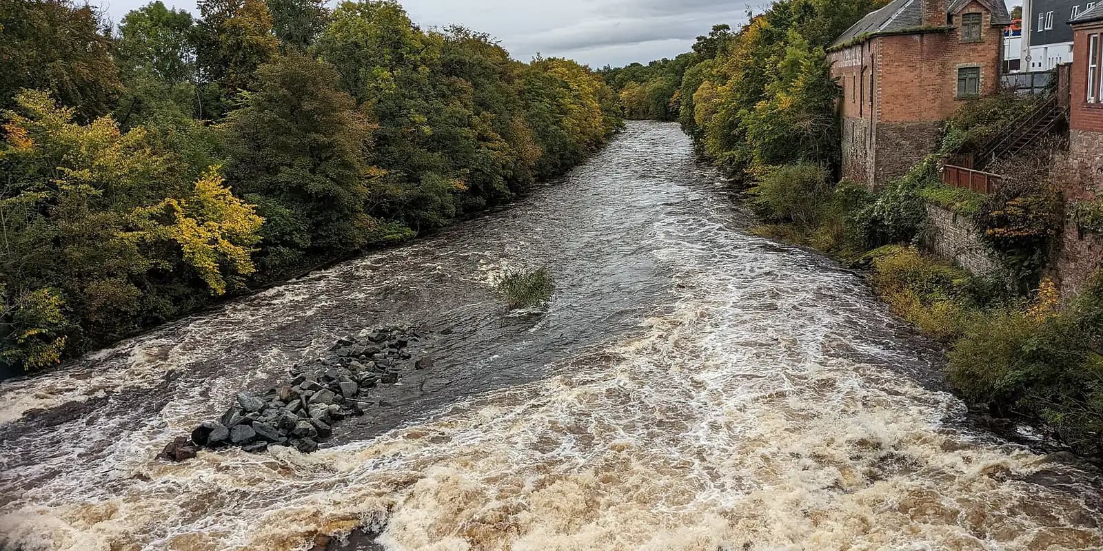 The River Ericht rushing between autumn trees in Blairgowrie