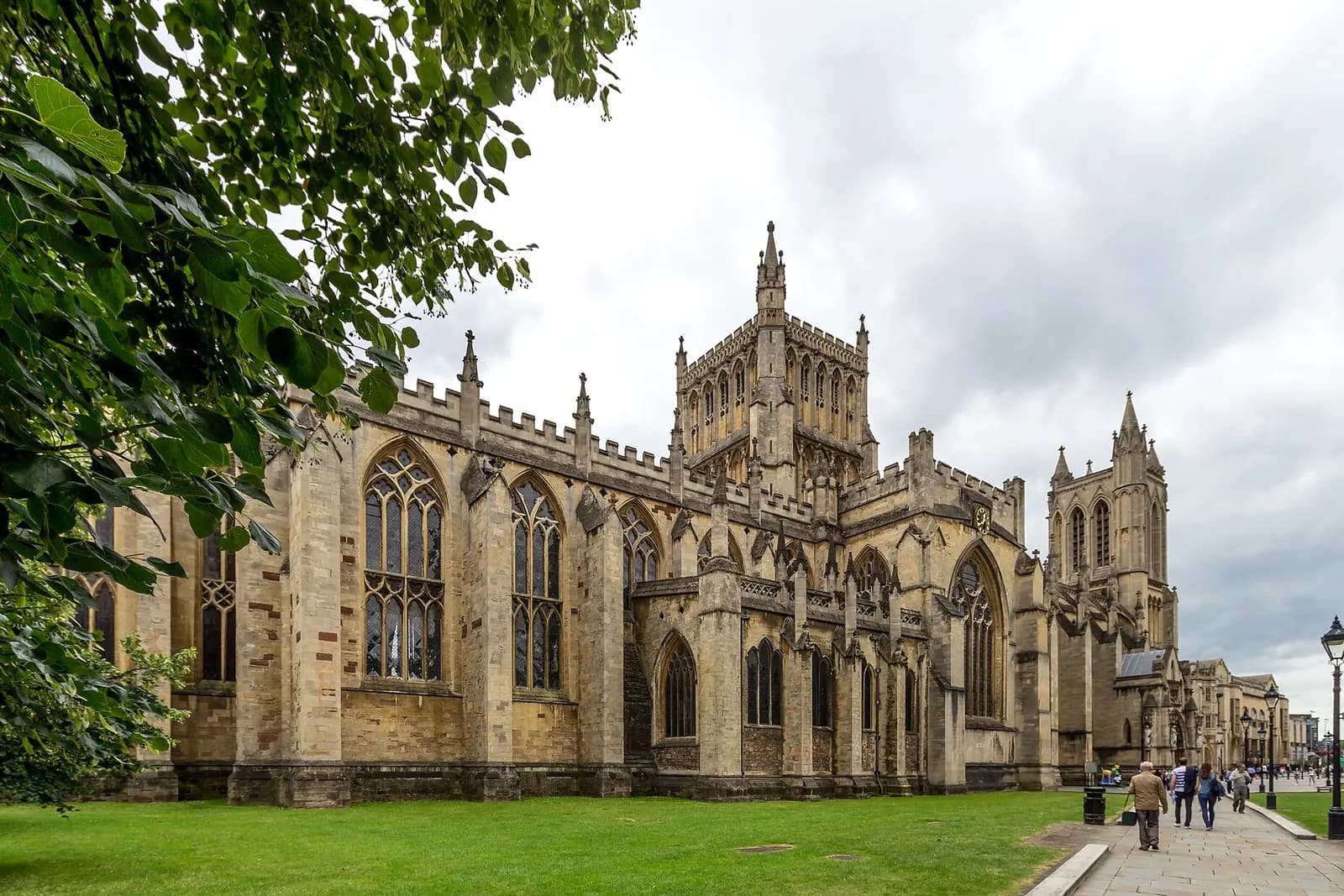 Bristol Cathedral's Gothic towers and long nave beside a green lawn