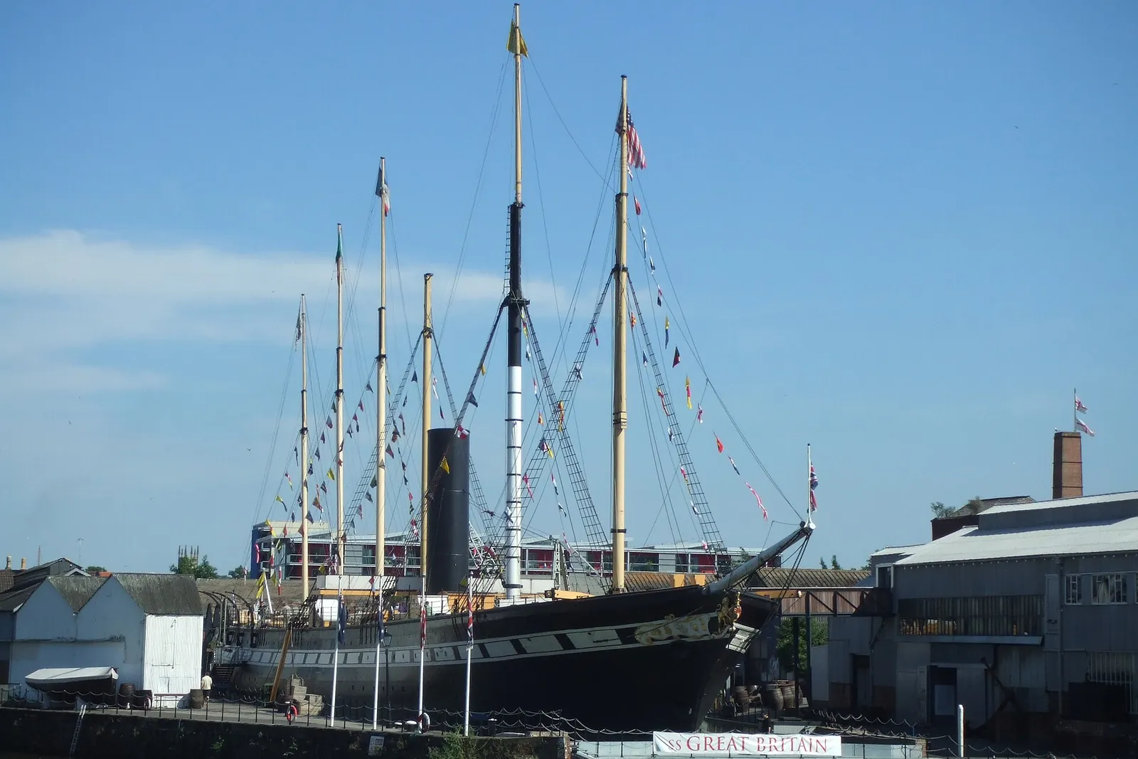 Brunel's SS Great Britain in her dry dock, with masts and rigging against a blue sky