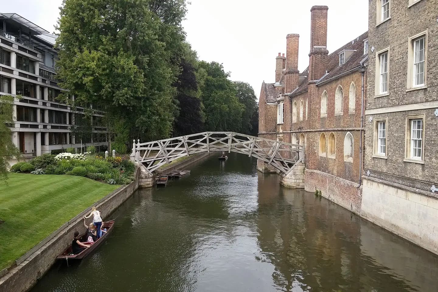 The wooden Mathematical Bridge over the River Cam at Queens' College, with a punt below