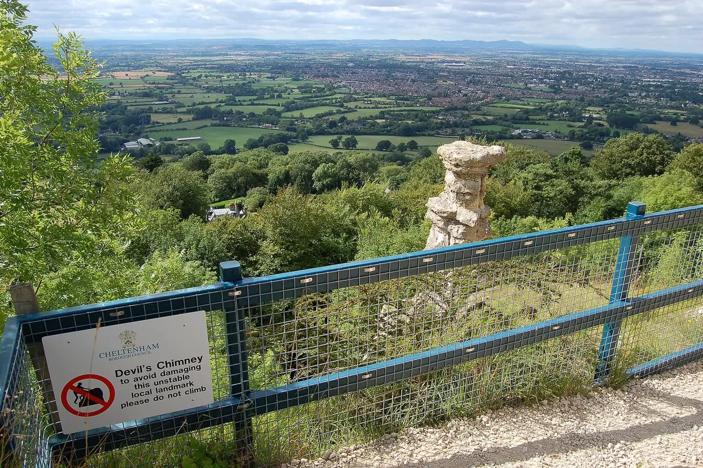 The Devil's Chimney rock pillar on Leckhampton Hill, with Cheltenham spread out below
