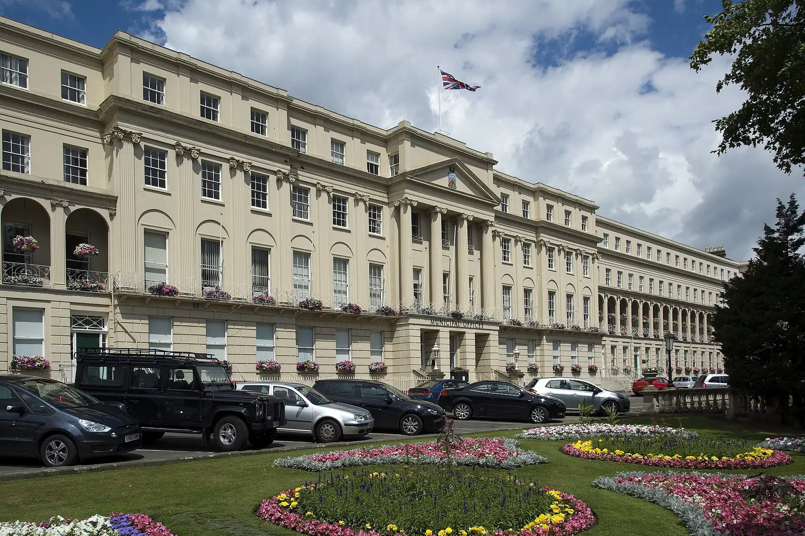 Cheltenham's Regency Municipal Offices behind formal flower beds on the Promenade
