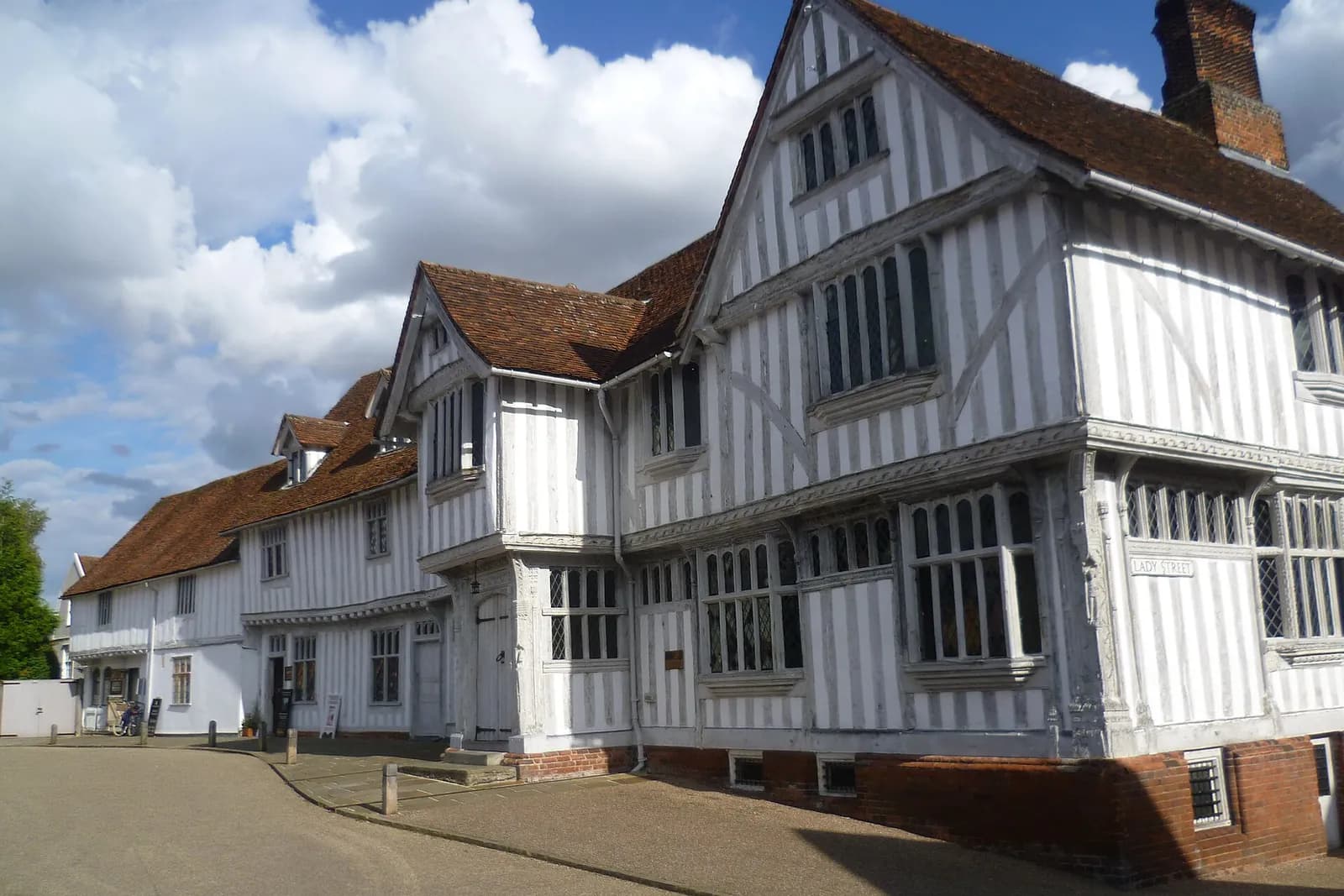 Lavenham's black-and-white timber-framed Guildhall under a summer sky