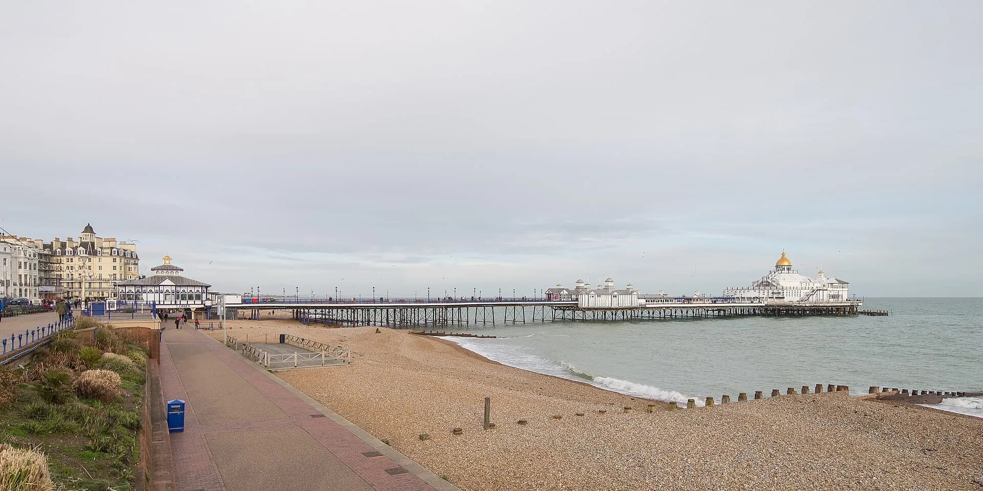 Eastbourne's long shingle beach and promenade, with the pier stretching out to sea