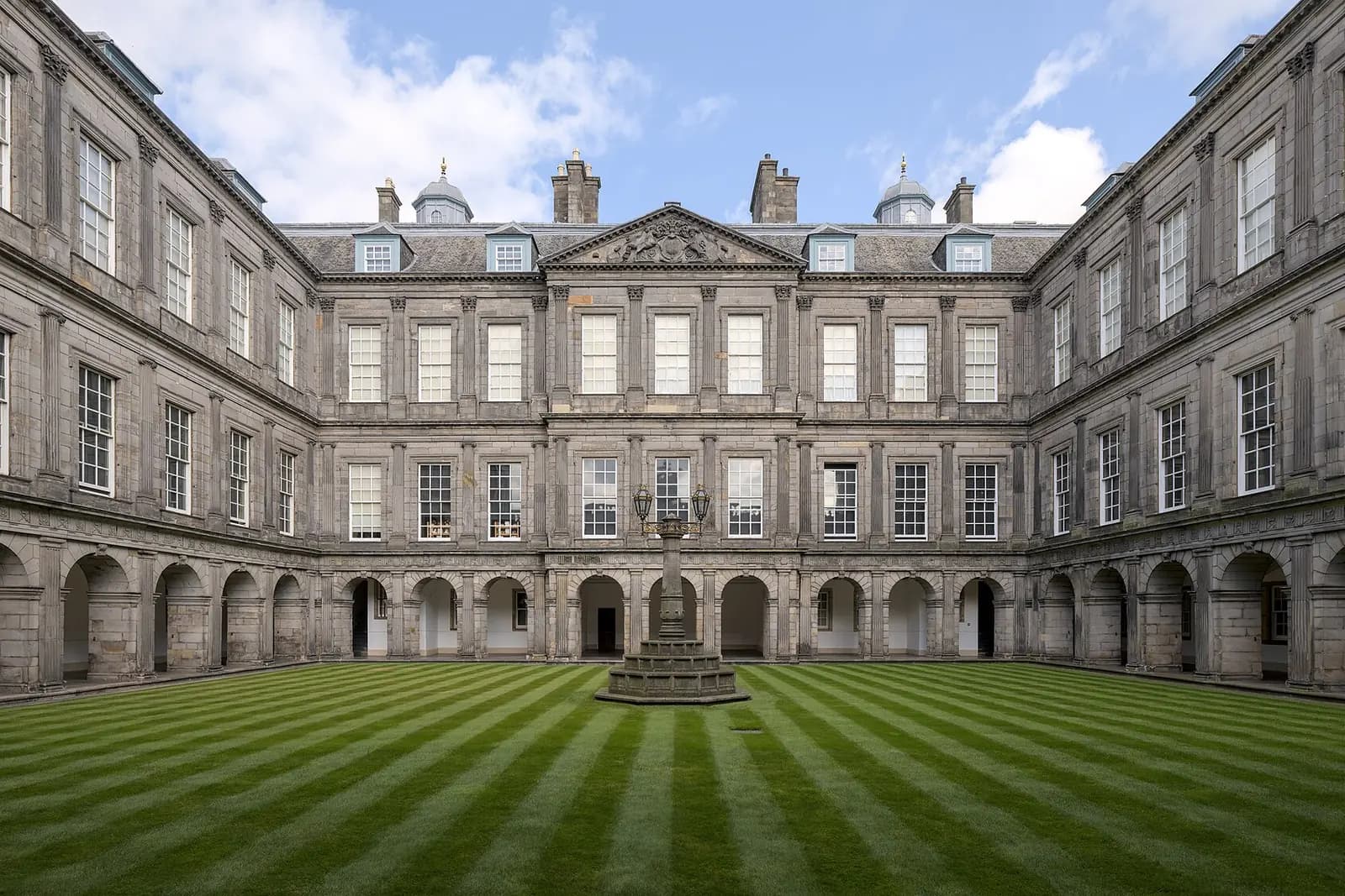 The inner quadrangle of the Palace of Holyroodhouse, with a striped lawn