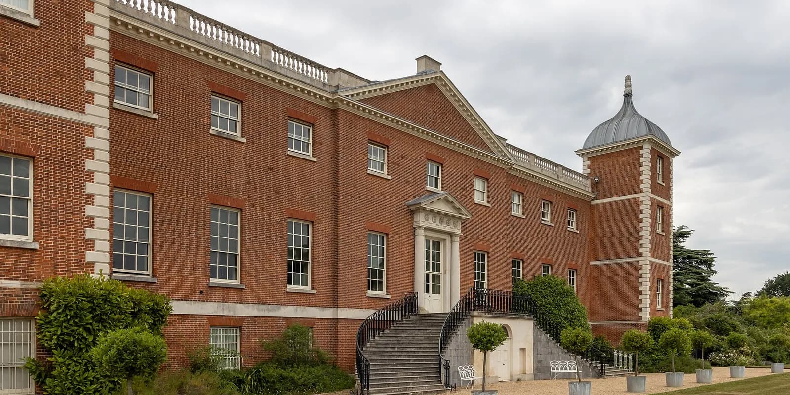 The red-brick back of Osterley House, with steps up to the door and a corner tower