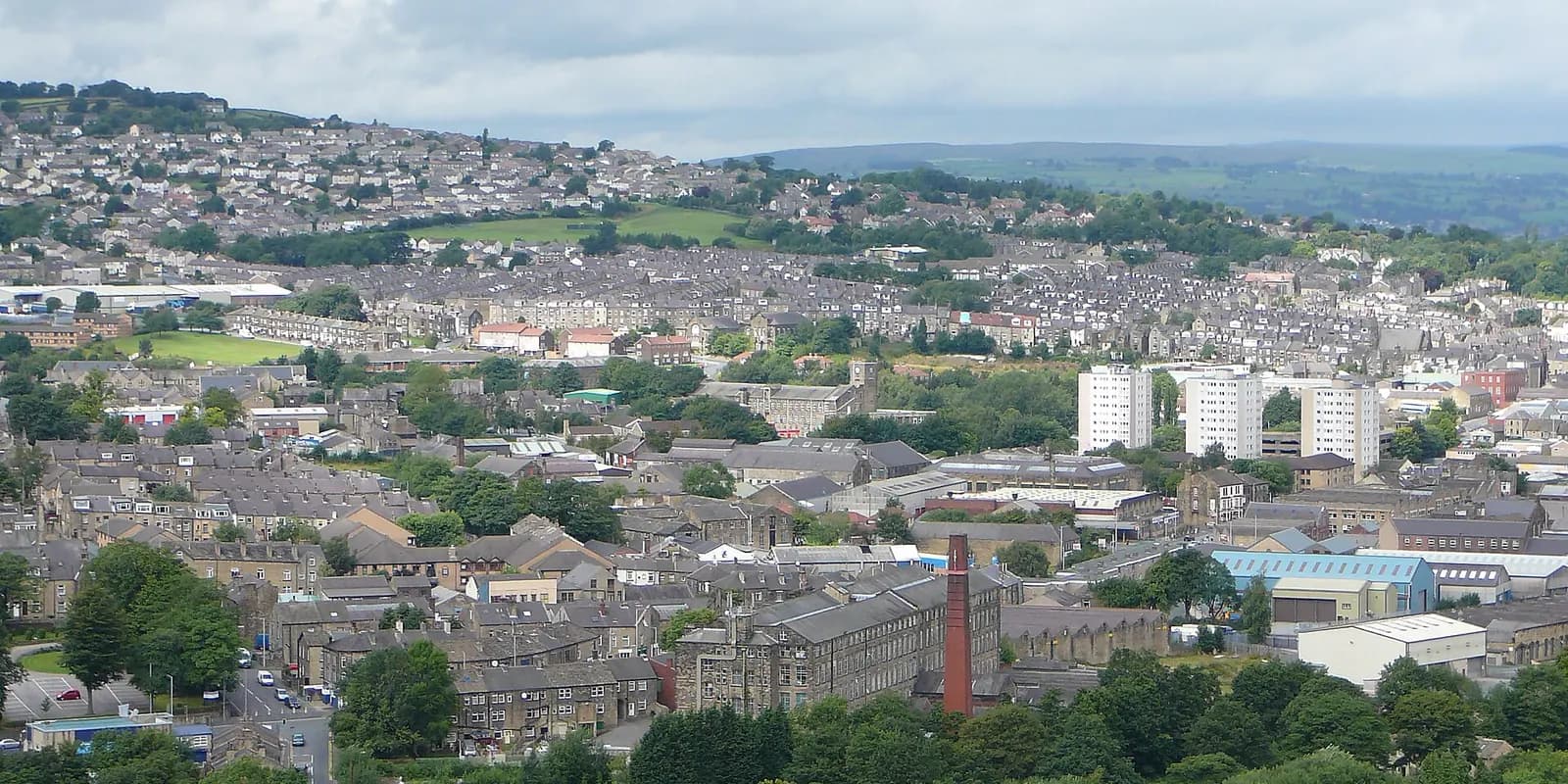 Keighley's rooftops and mill chimneys spread across the valley, with moorland hills beyond