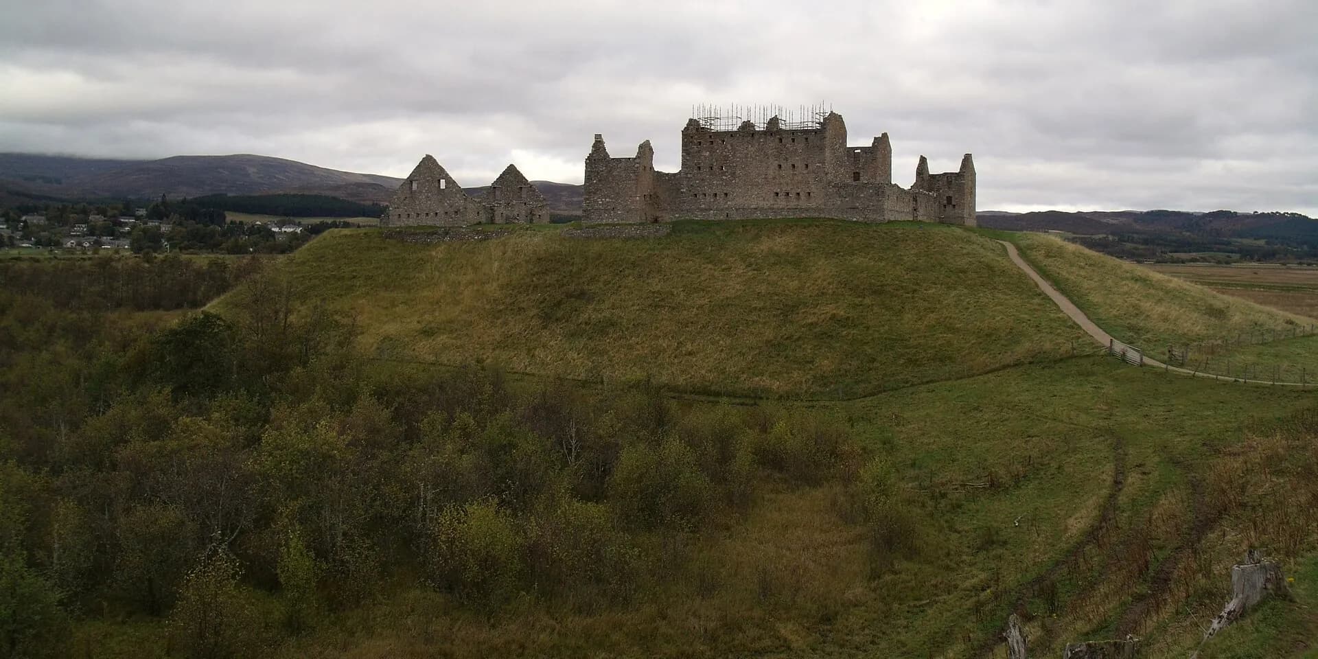 The ruined walls of Ruthven Barracks on a grassy mound above the Spey valley