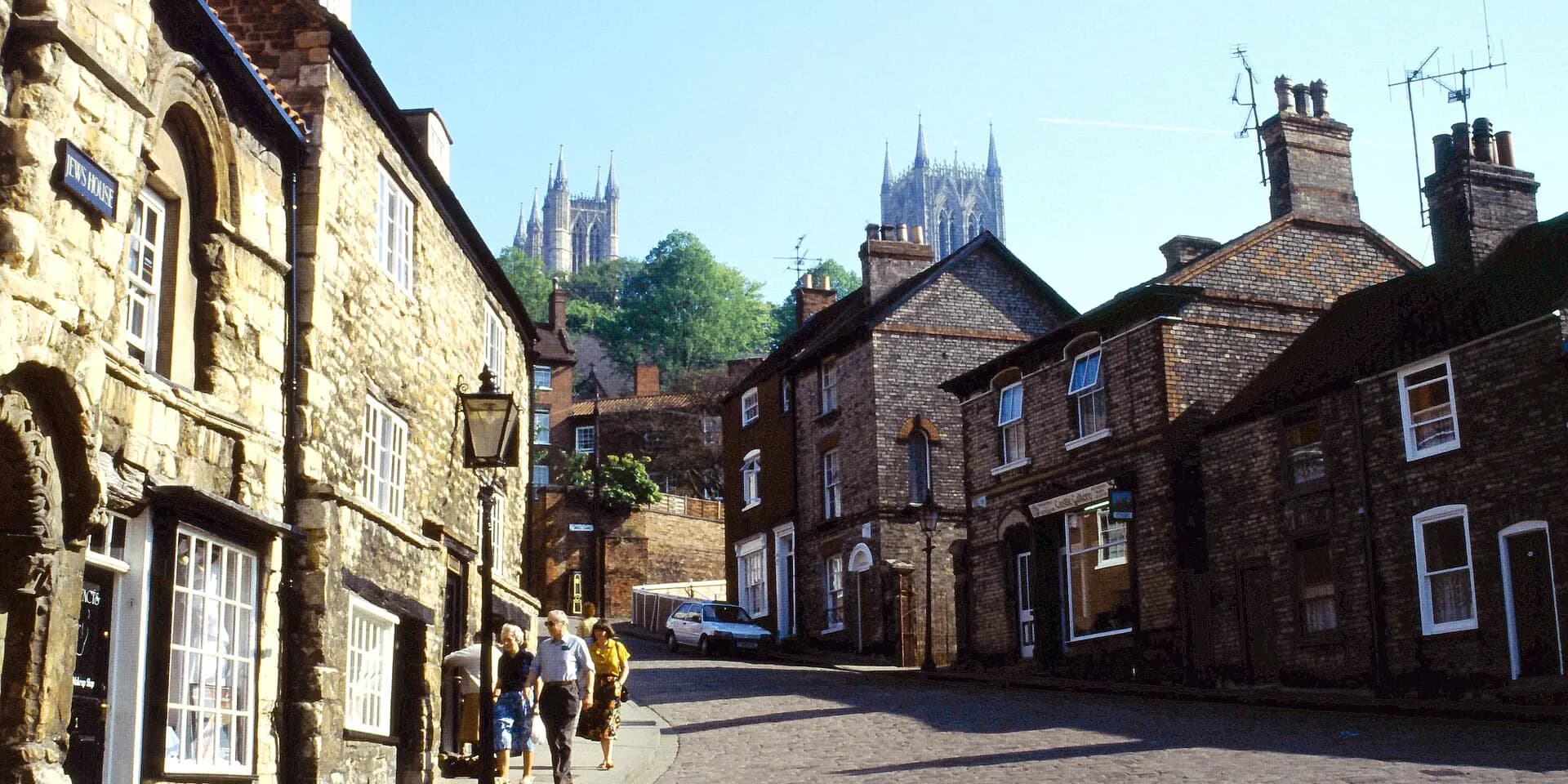 Old stone and brick houses on Steep Hill, with the towers of Lincoln Cathedral rising behind