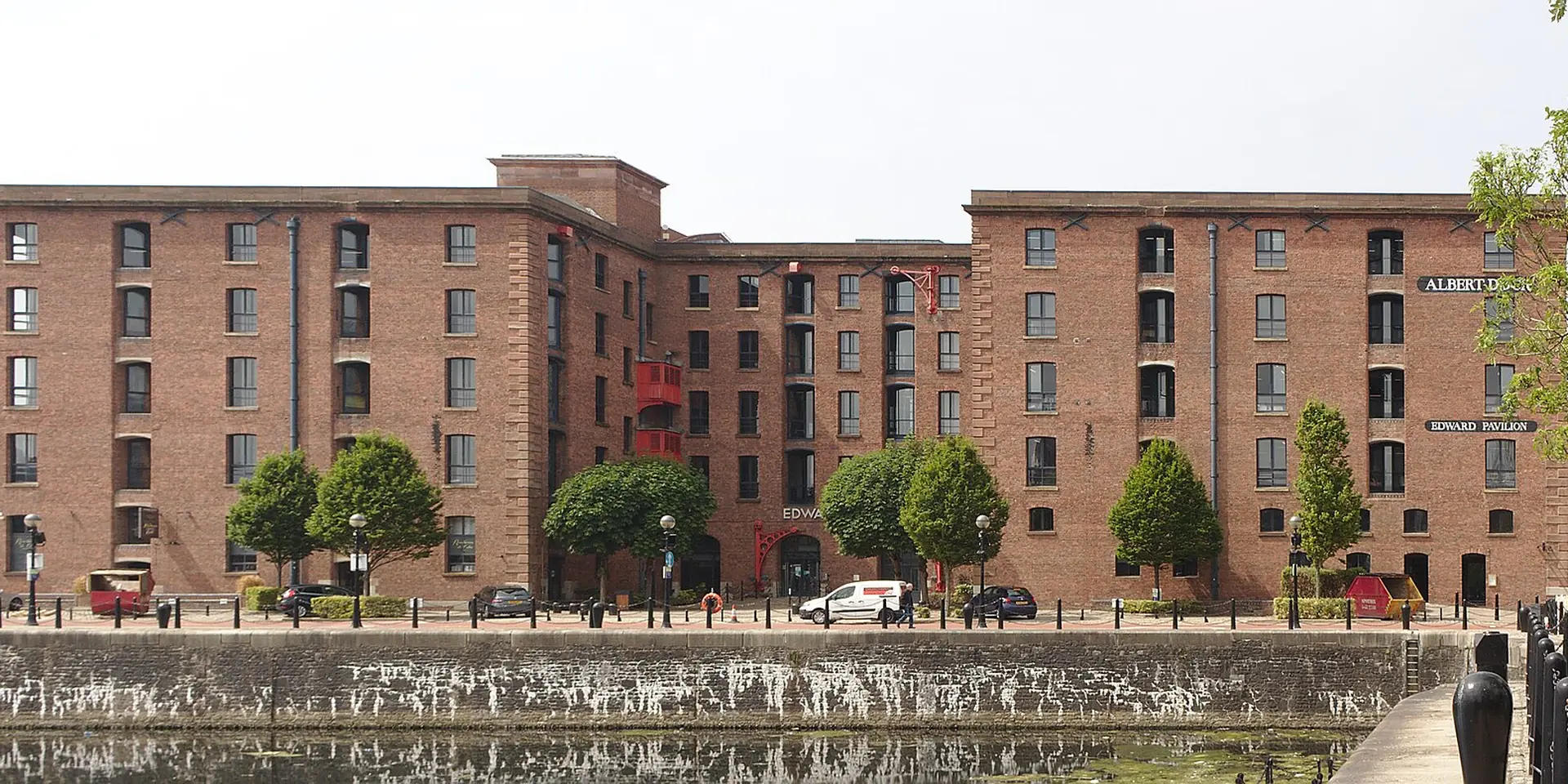 The red-brick warehouses of the Royal Albert Dock reflected in the dock water