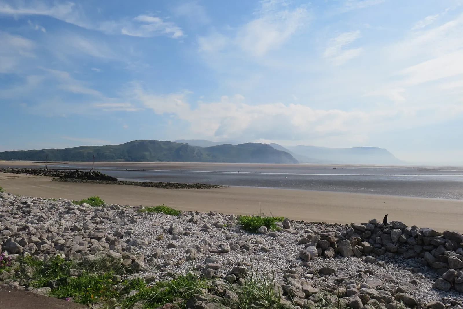 The quiet sands of Llandudno's West Shore, looking across the estuary to the hills