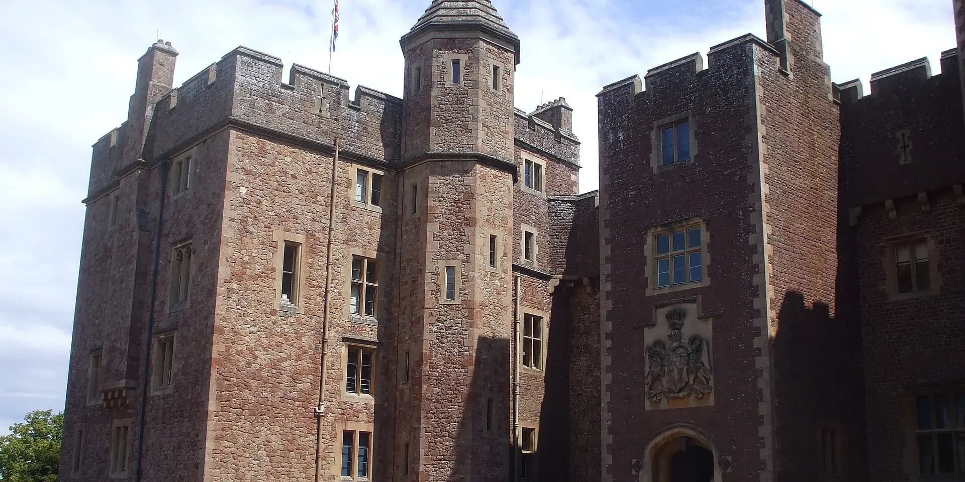 The red sandstone towers and gatehouse of Dunster Castle