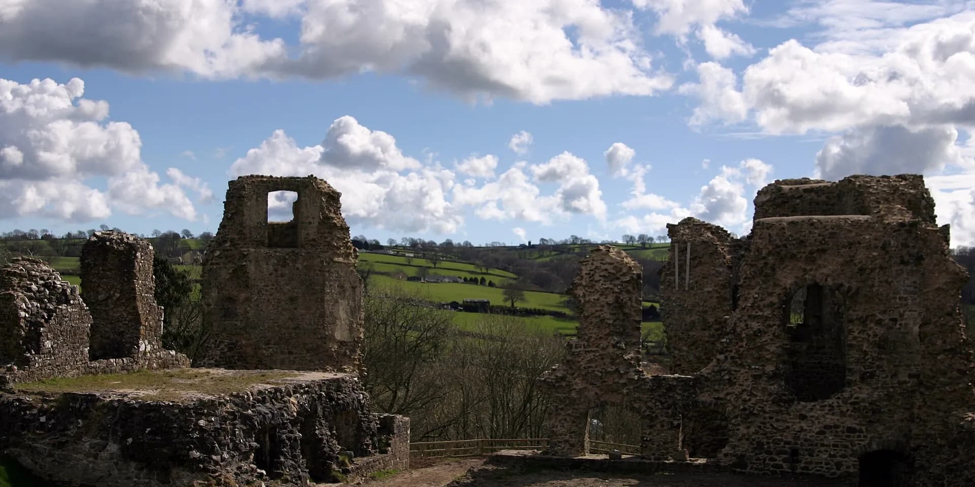 The ruined stone towers of Narberth Castle, with green Pembrokeshire fields beyond