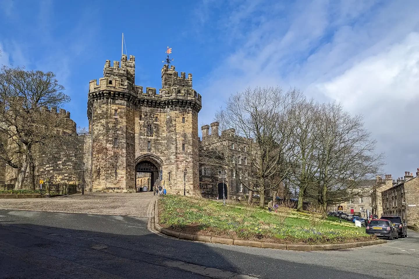 The great gatehouse of Lancaster Castle with its twin towers, under a blue sky