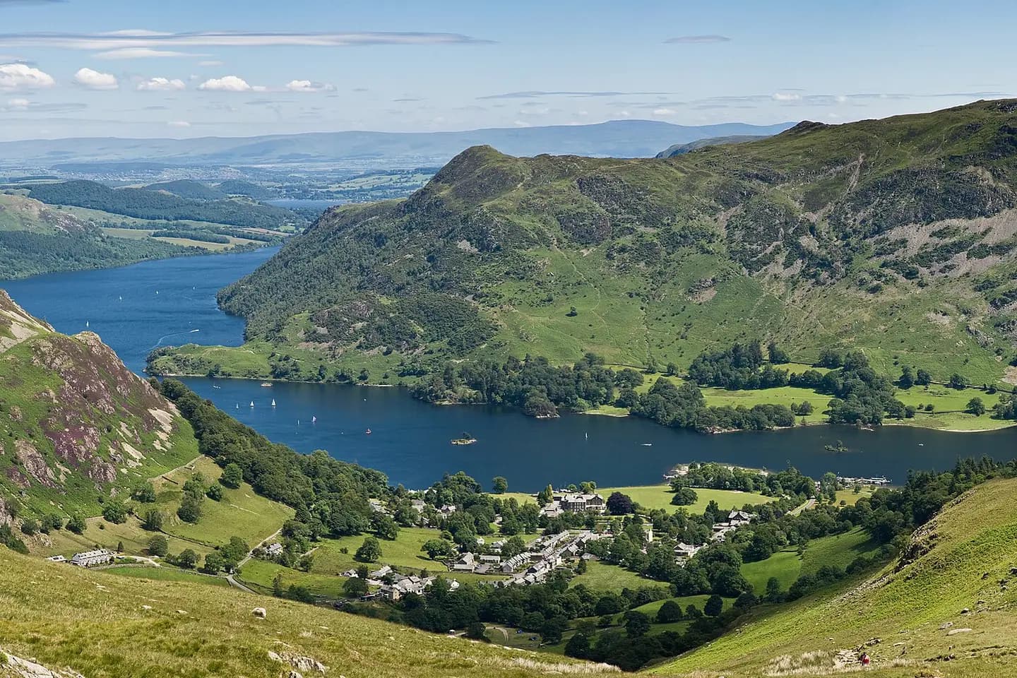 Ullswater stretching away between green fells, with the village of Glenridding by the shore