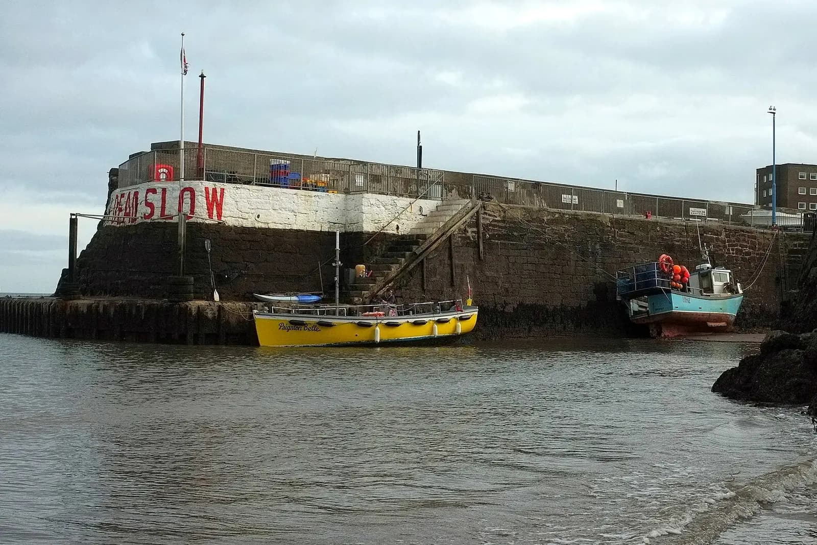 Fishing boats in Paignton's small harbour below the harbour wall