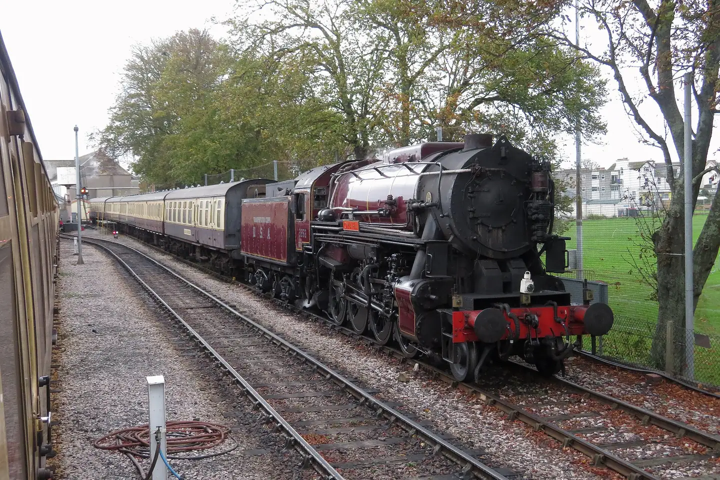 A steam locomotive pulling coaches into Paignton on the Dartmouth Steam Railway