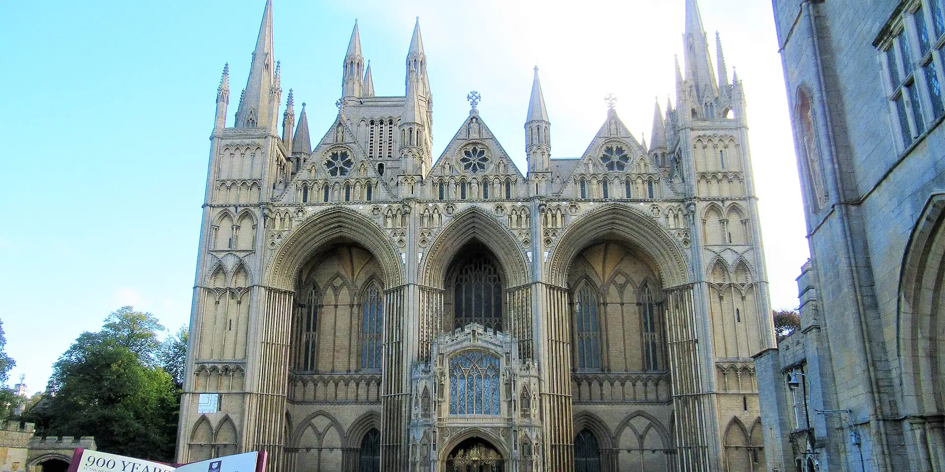 The soaring west front of Peterborough Cathedral, with three great arches and pinnacles