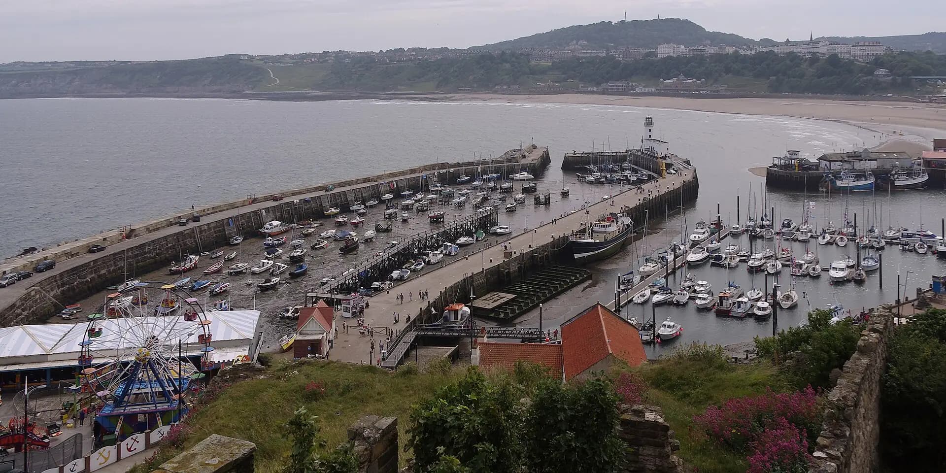Scarborough harbour and its boats seen from the castle, with South Bay curving away beyond