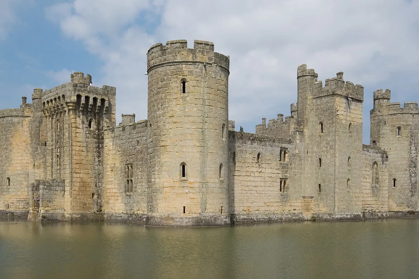Bodiam Castle's round towers and walls rising from its moat
