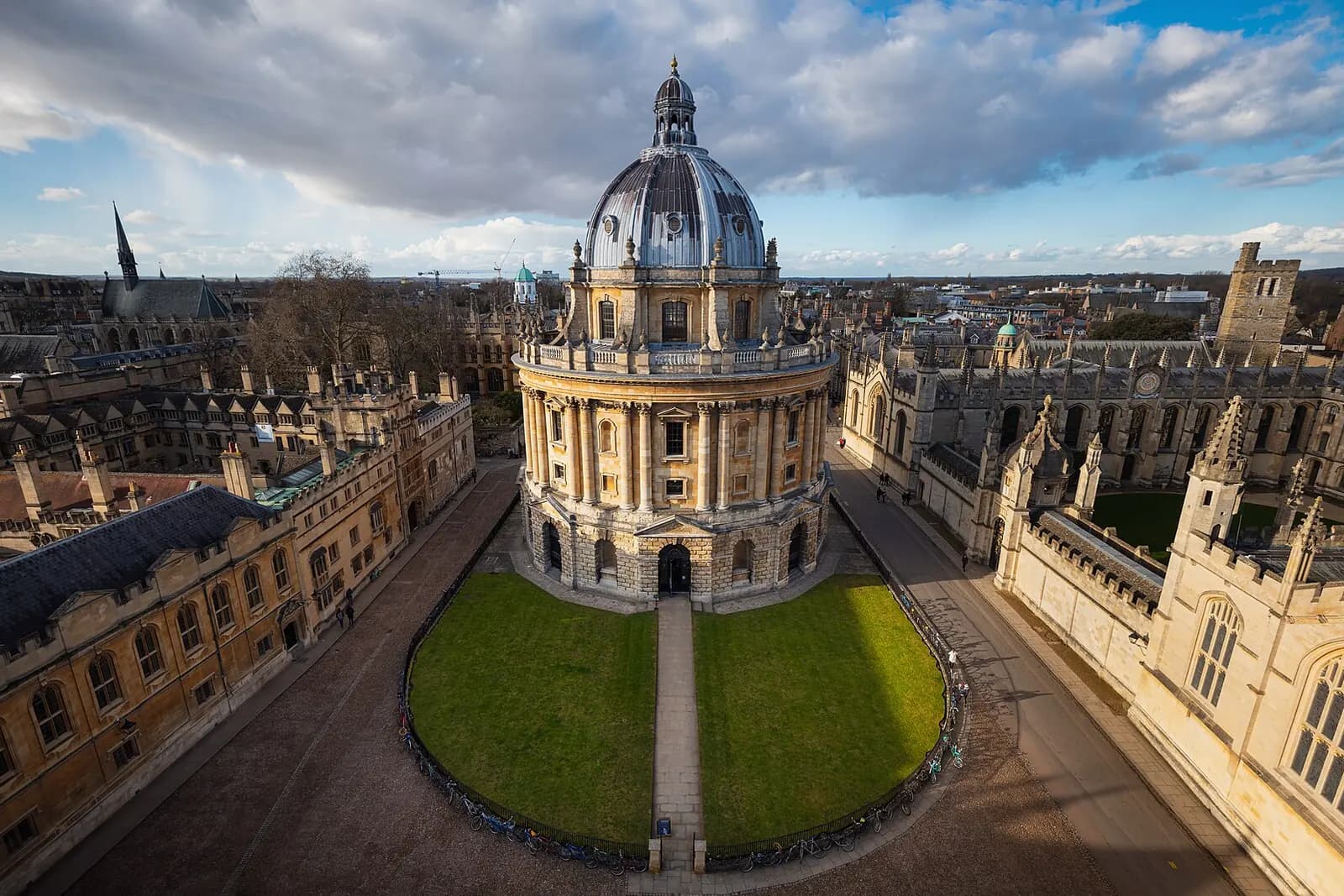 The domed Radcliffe Camera on its round lawn, surrounded by Oxford's college buildings, seen from above