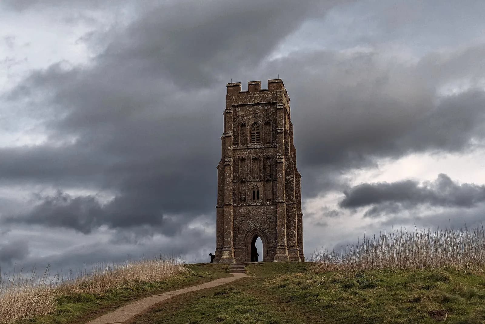 St Michael's Tower on top of Glastonbury Tor under a dramatic cloudy sky