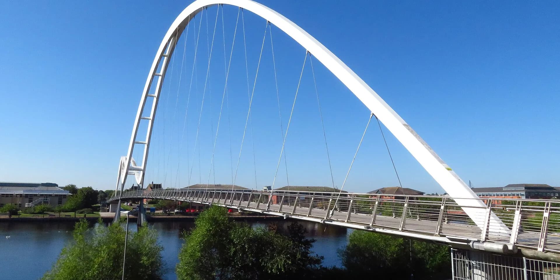 The white double arch of the Infinity Bridge over the River Tees