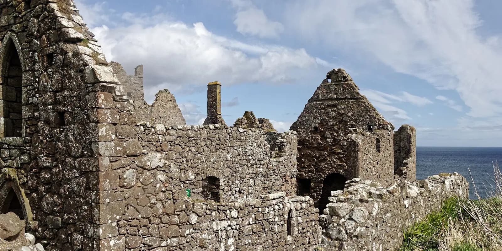 The ruined stone buildings of Dunnottar Castle on its clifftop above the sea