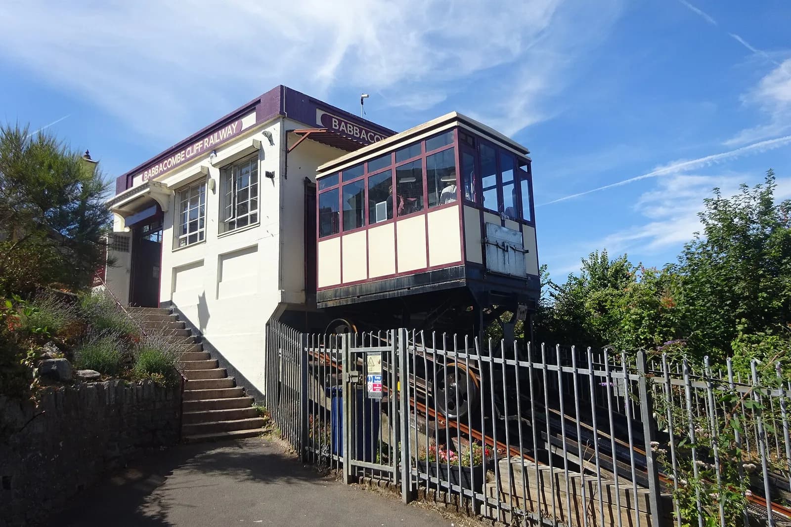 A car of the Babbacombe Cliff Railway at its top station, among trees