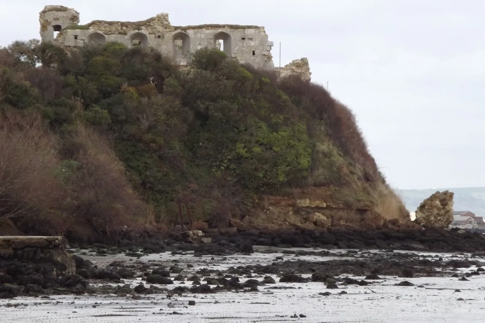 The ruins of Sandsfoot Castle on the clifftop above the shore of Portland Harbour