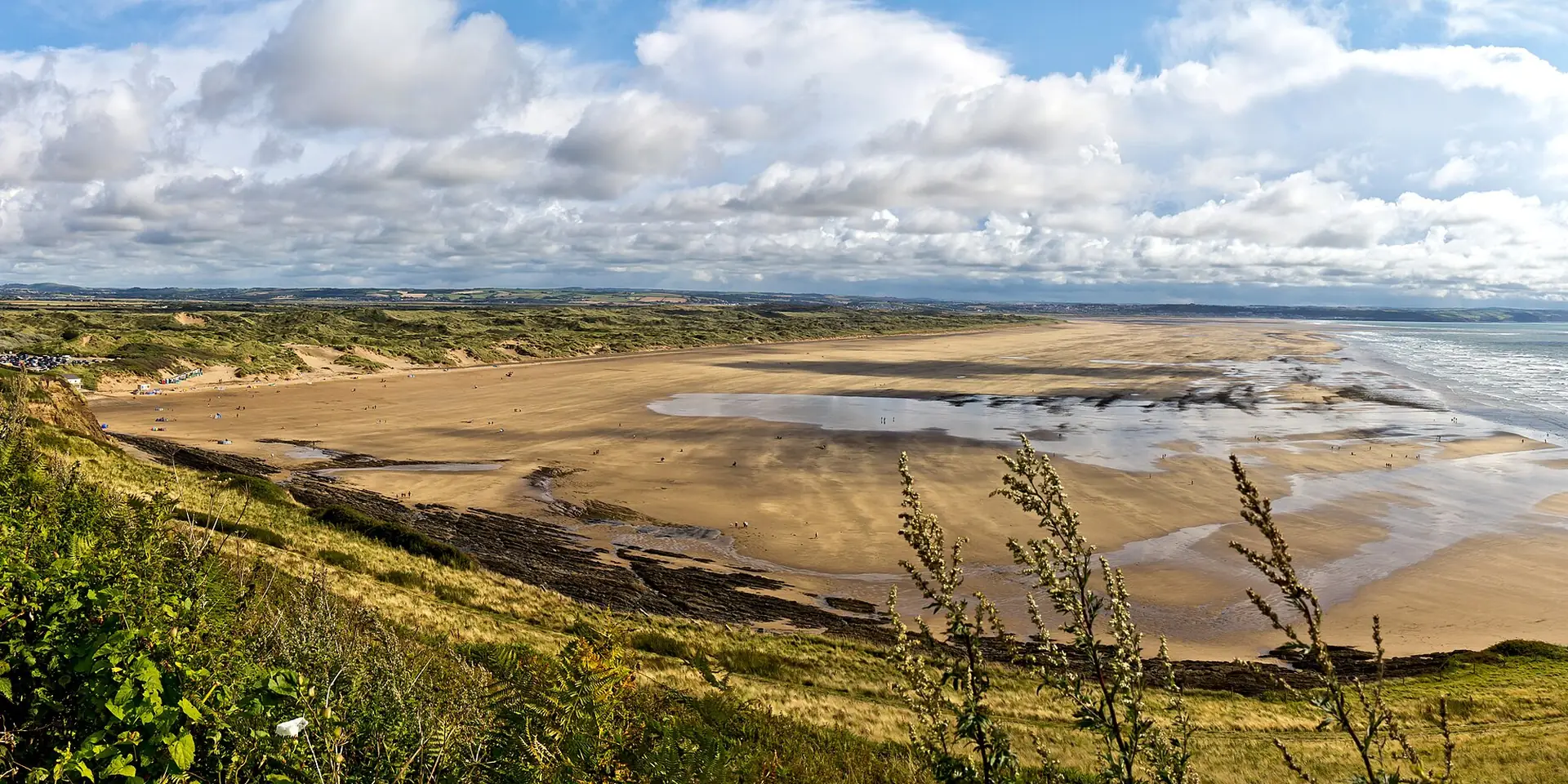 The long golden sweep of Saunton Sands and the dunes of Braunton Burrows, seen from the hillside