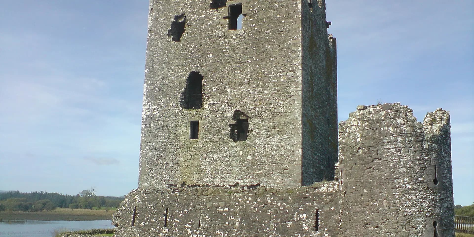 The ruined stone tower of Threave Castle on its island, beside the River Dee