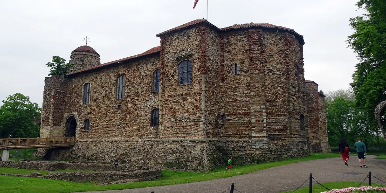 The Norman keep of Colchester Castle among the lawns and trees of Castle Park
