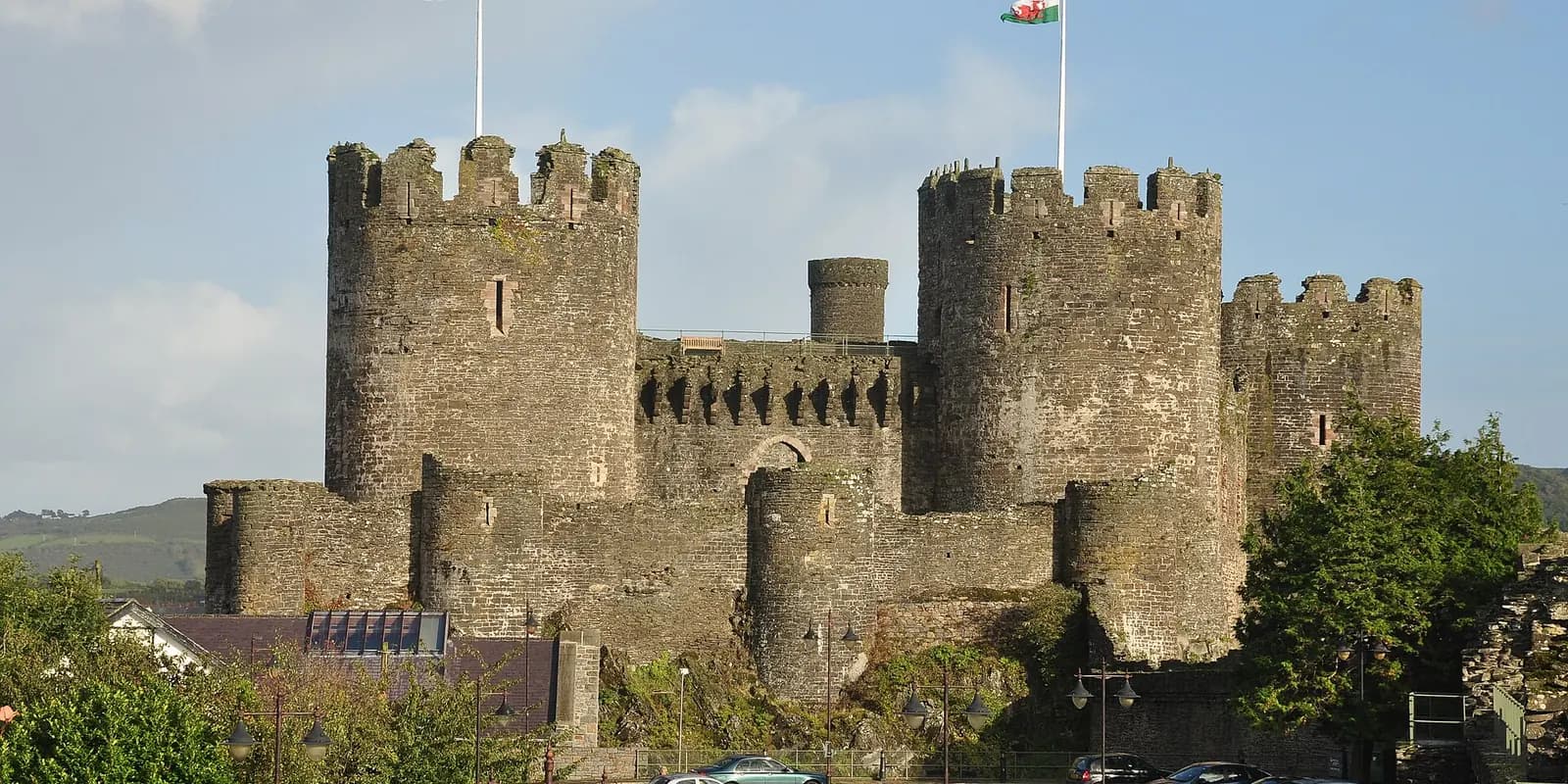 Conwy Castle's round stone towers and walls under a blue sky