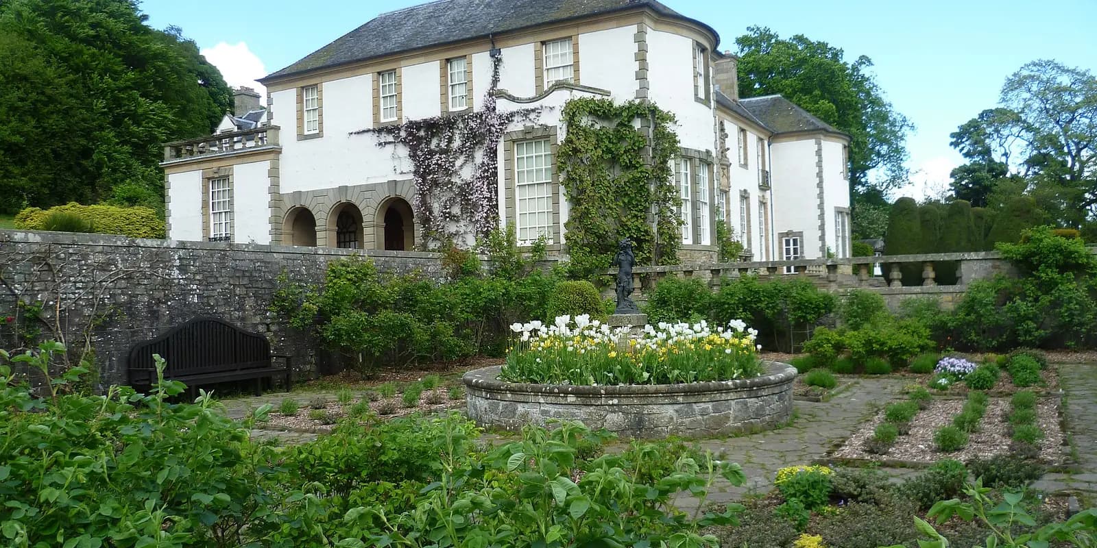 Hill of Tarvit, a white Edwardian house above terraced gardens with flower beds