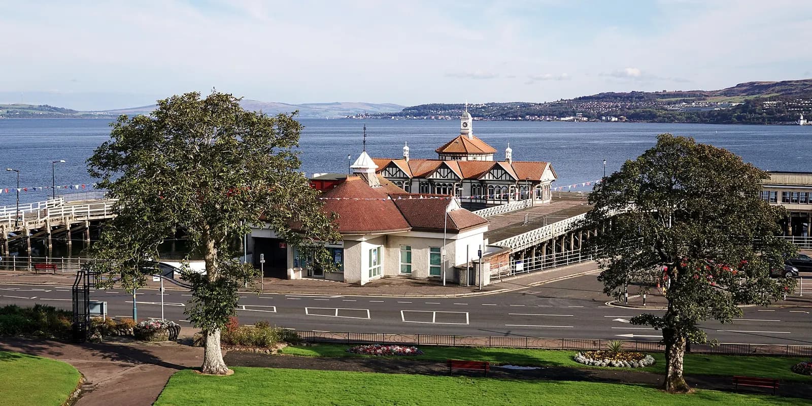 Dunoon's Victorian pier buildings on the Firth of Clyde, with gardens in front and hills across the water
