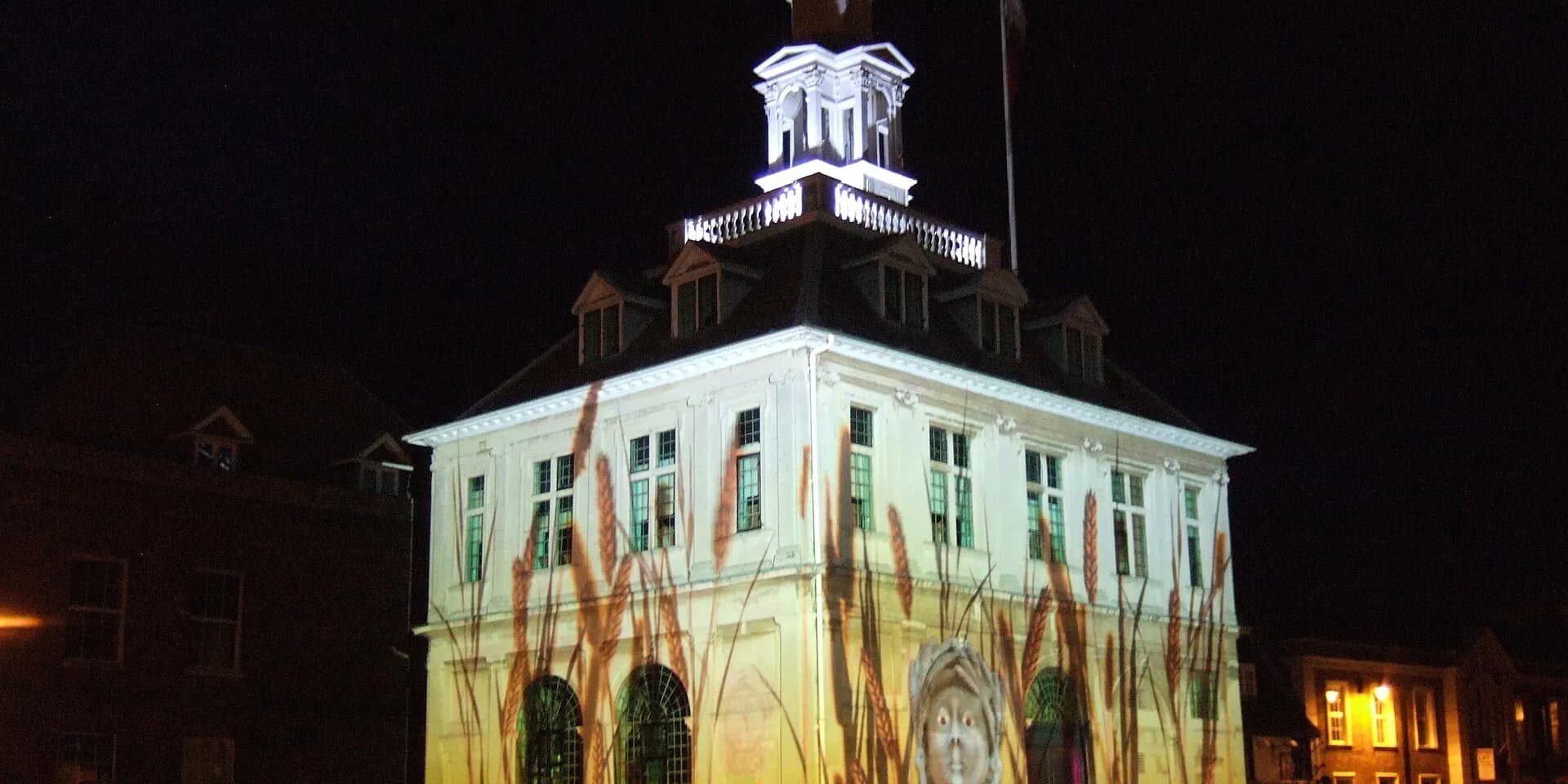 King's Lynn's Custom House lit up with a projected light show at night