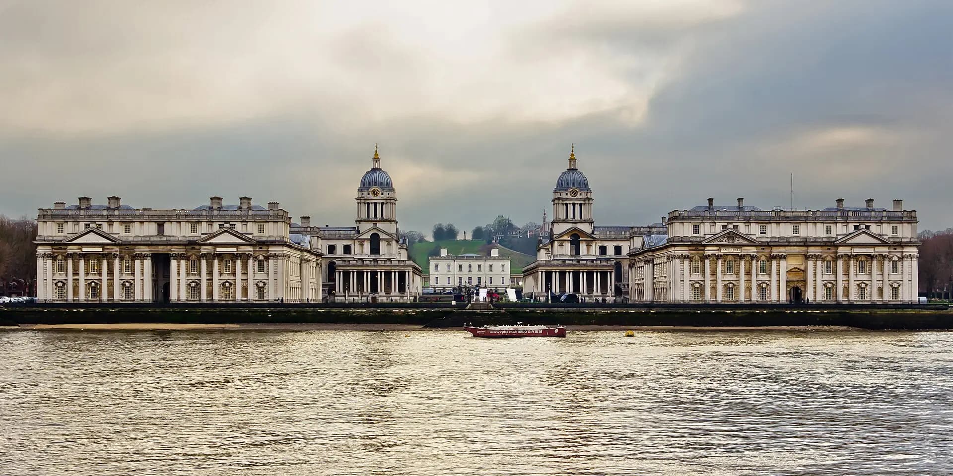 The twin domes and colonnades of the Old Royal Naval College at Greenwich, seen across the Thames