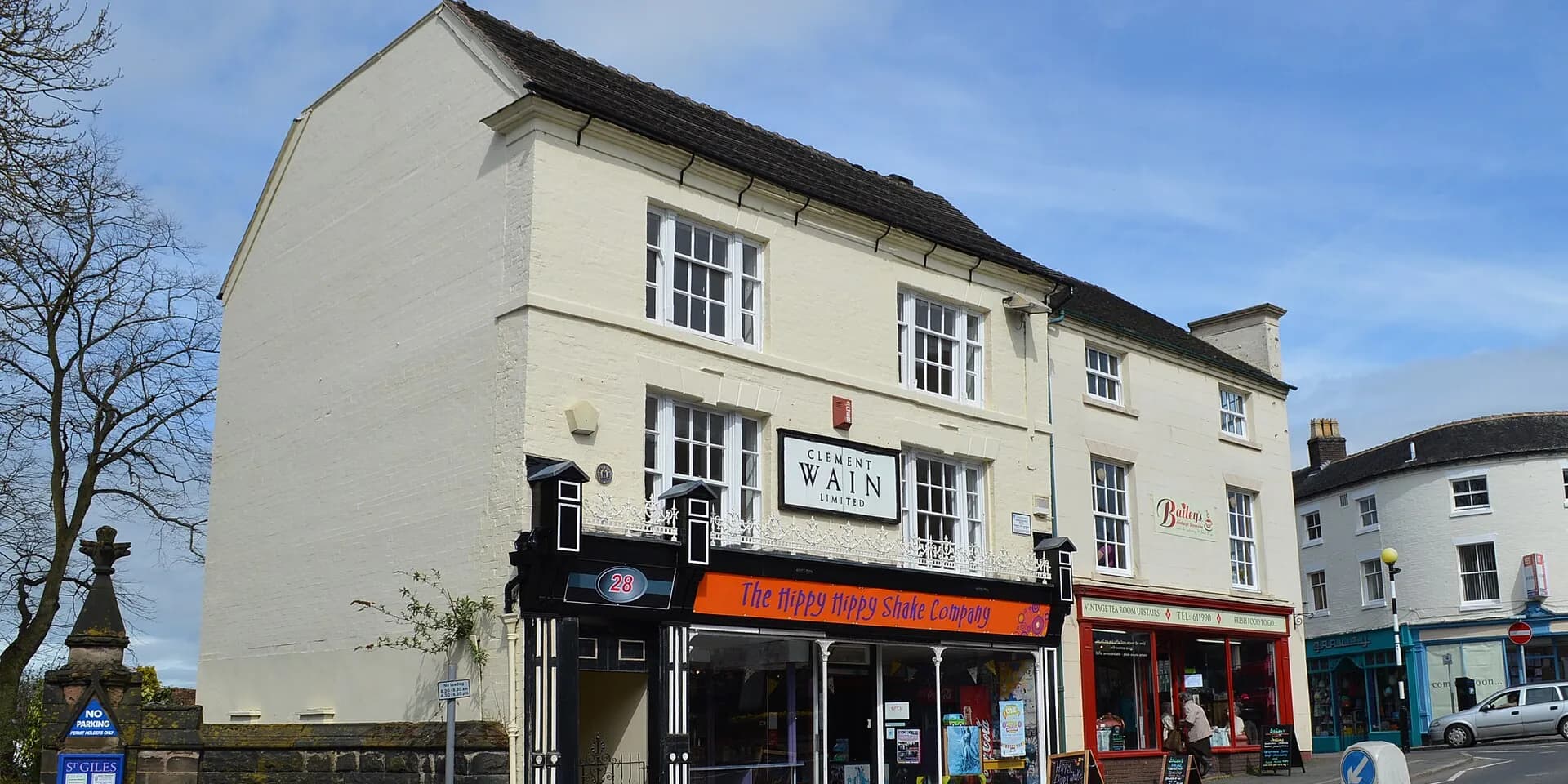 Georgian buildings and shopfronts on Newcastle-under-Lyme's High Street under a blue sky