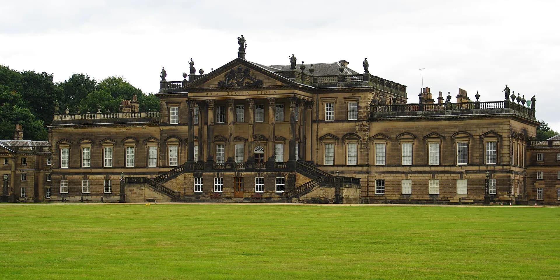 The long Palladian front of Wentworth Woodhouse above a wide green lawn