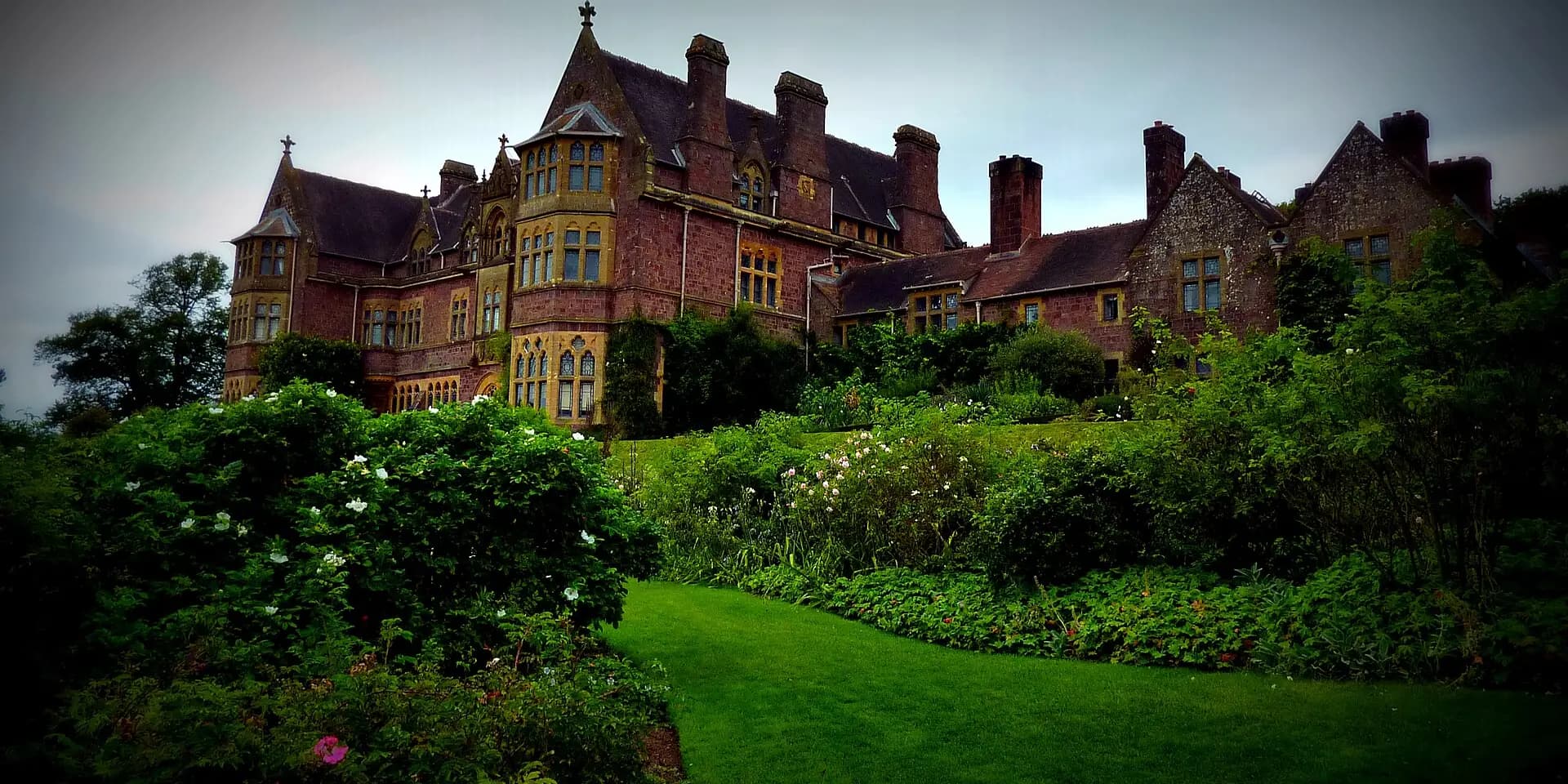Knightshayes, a Victorian red-stone country house, above its gardens