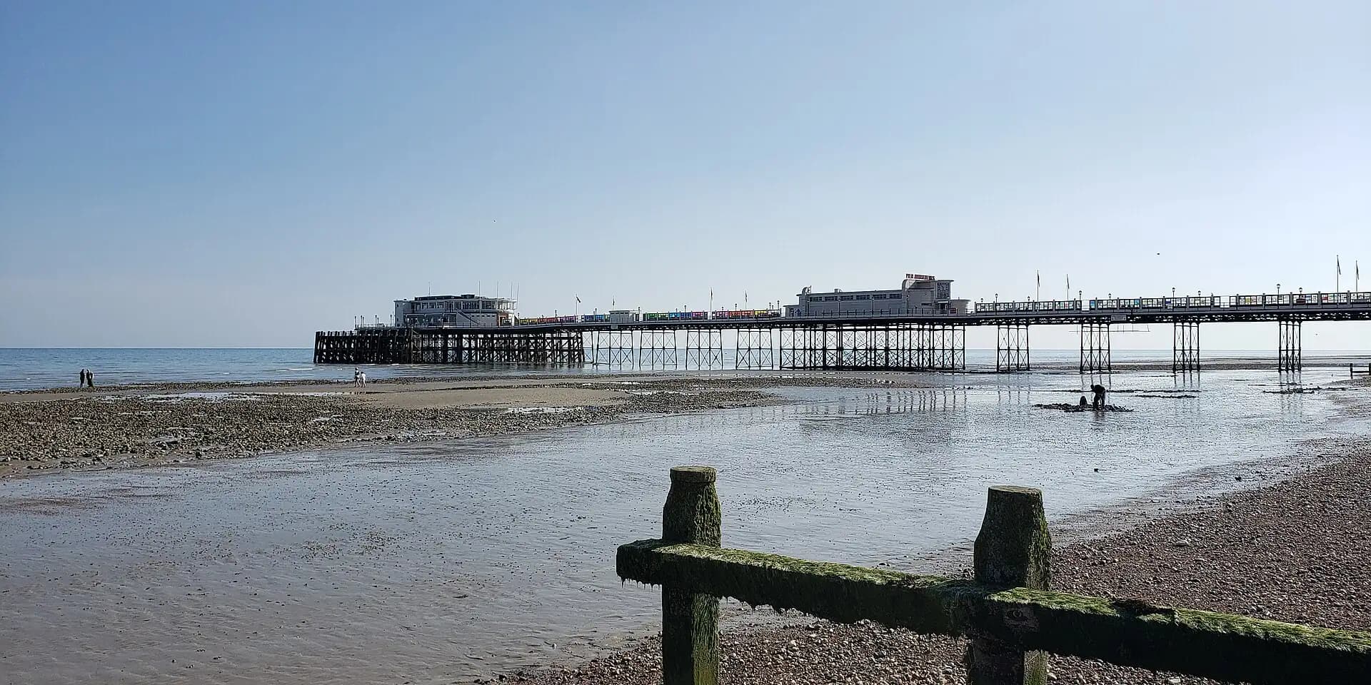 Worthing Pier stretching out over the sands at low tide